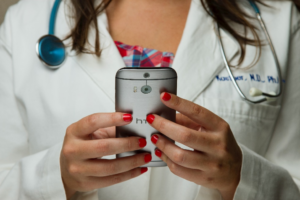 A doctor accessing data via their smartphone